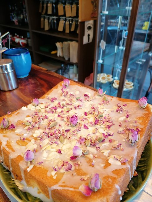 Persian Love cake: a fragrant rose cake flavored with freshly ground cardamom and almond flour, and topped with crushed pistachios and rose petals